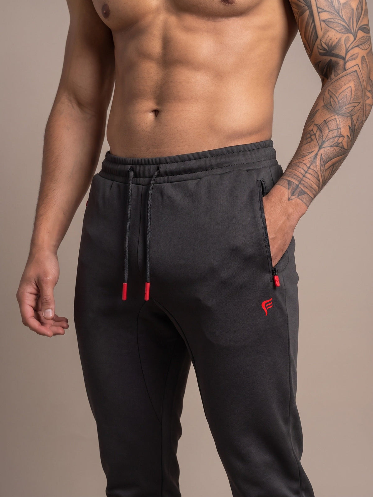 Men's Performance Joggers in Black, waistband and flame logo close-up