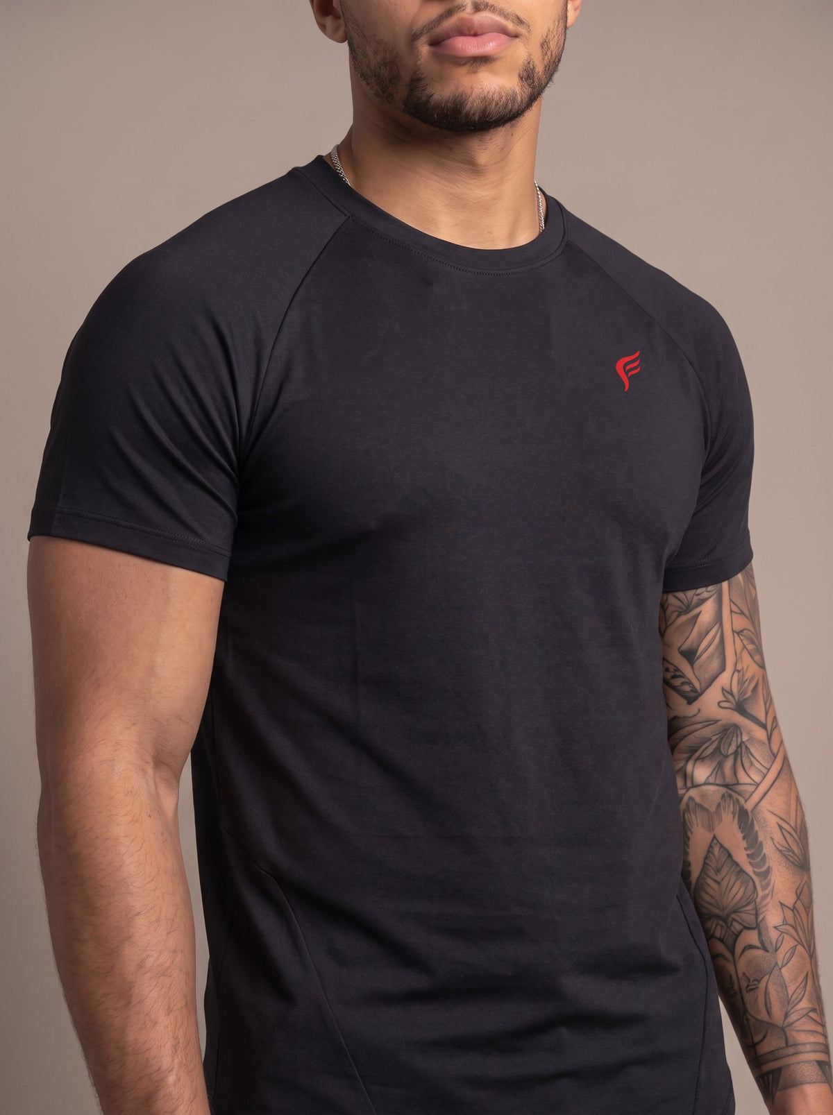 Men's Performance Tee in Black, chest logo close-up