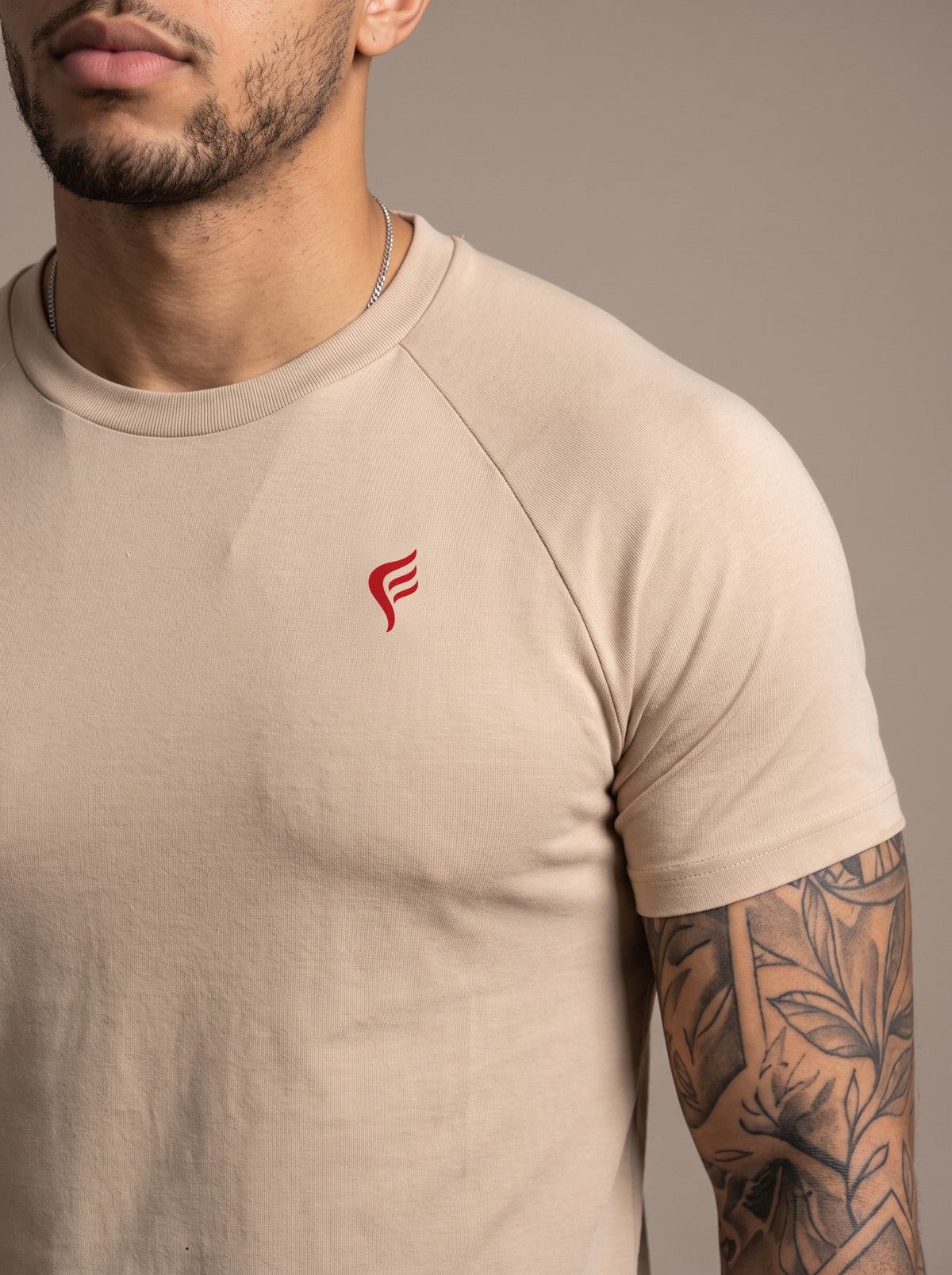 Men's Performance Tee in Macadamia, chest logo close-up
